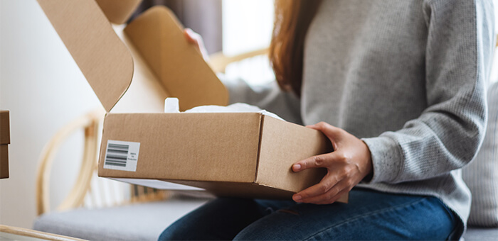 Woman opening packaging box