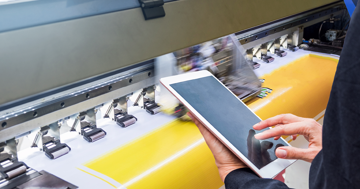 A print production operator using a tablet