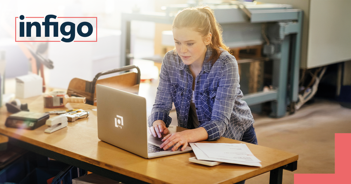Woman working on Laptop in Print Shop