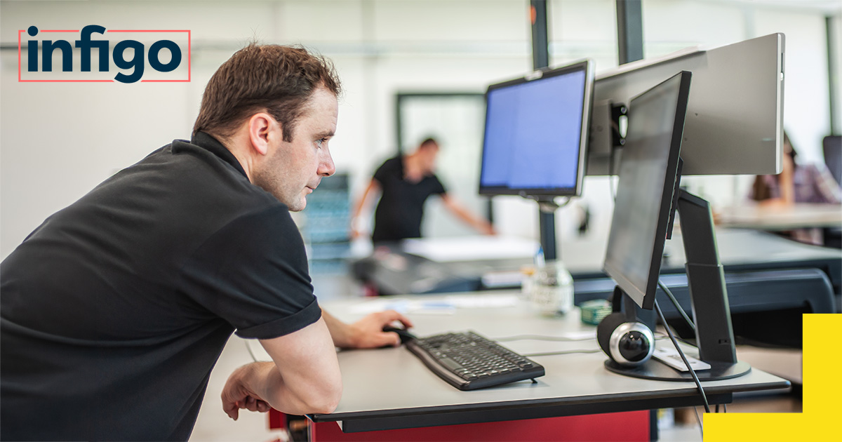 Print operator reviewing data on their computer in a print warehouse