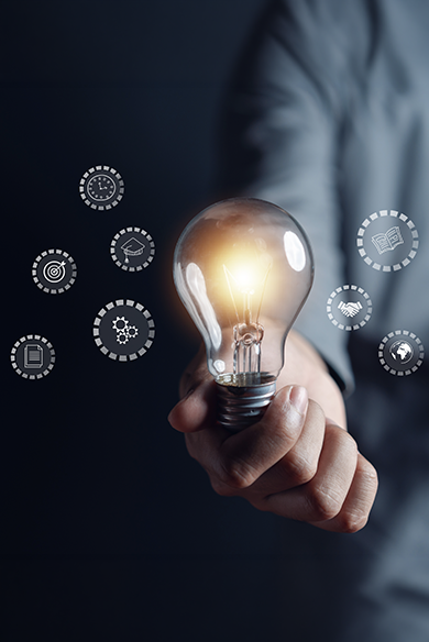 Person holding light bulb with symbols