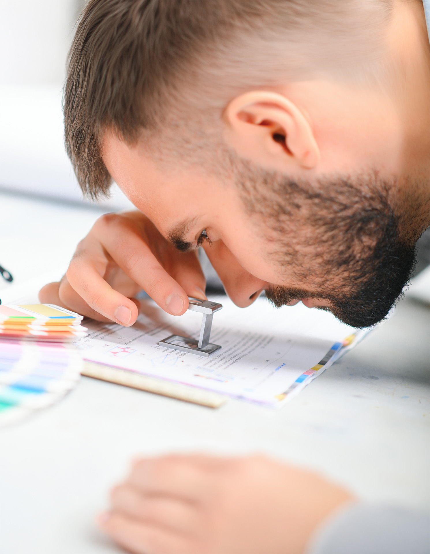 Prepress operator reviewing paper quality
