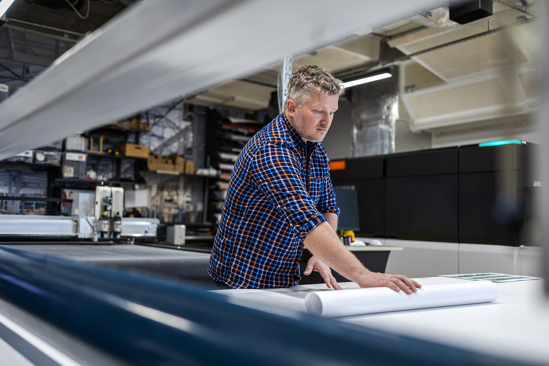 Print operator reviewing printed material