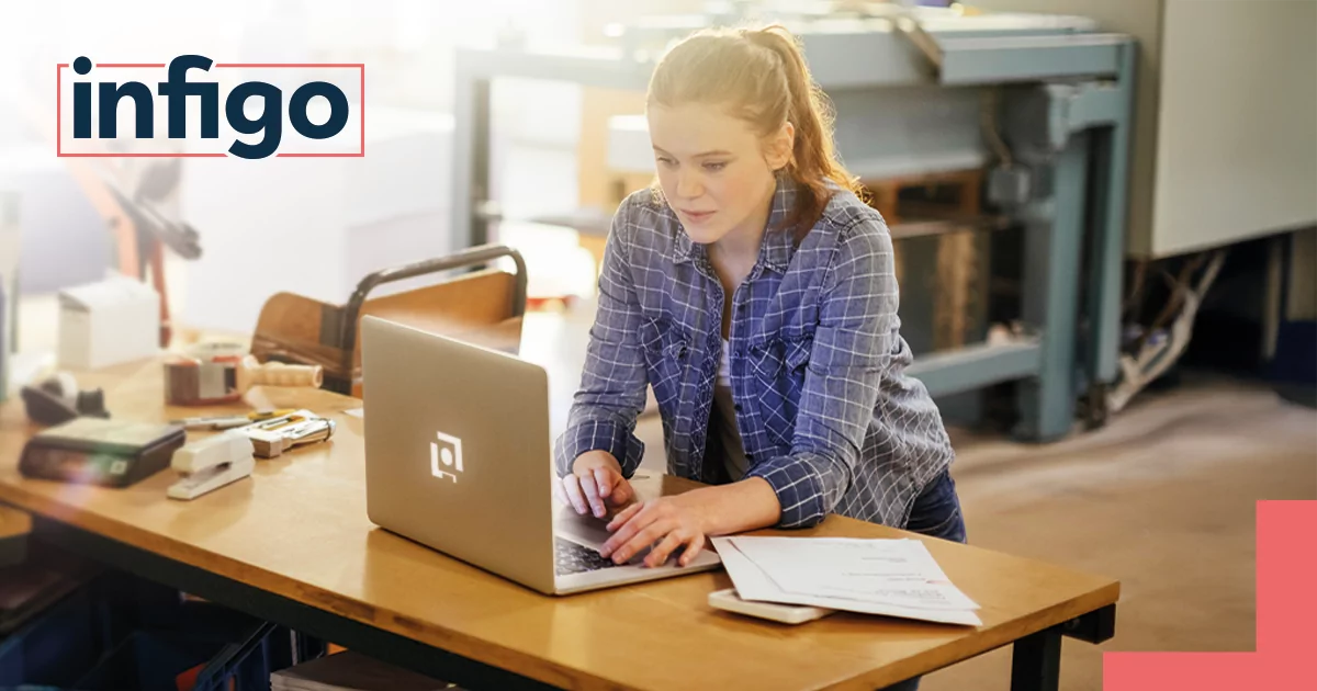 Woman working on Laptop in Print Shop