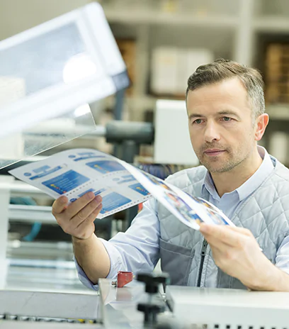 Man taking printed material out of printer