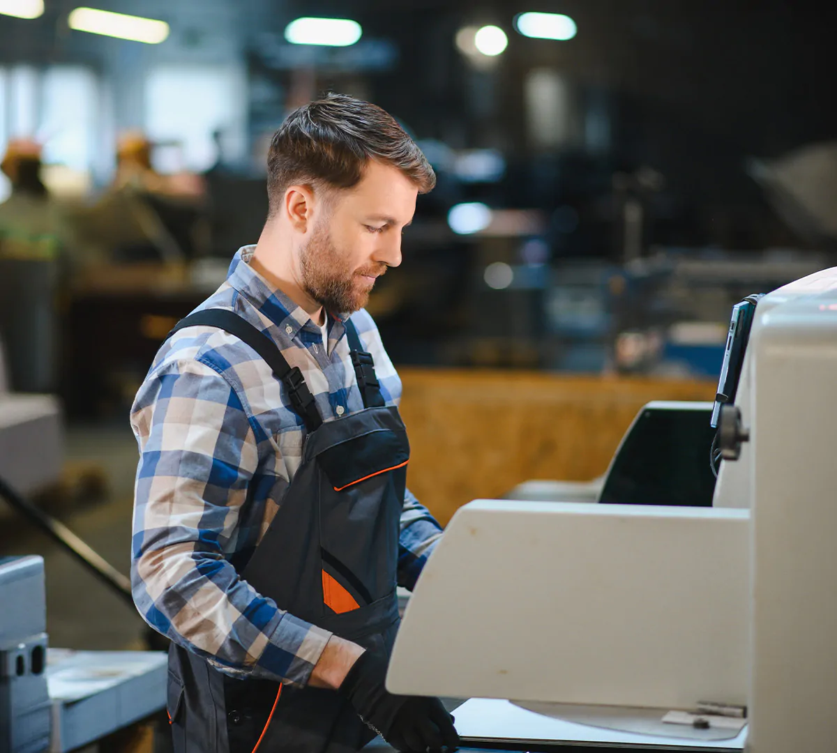 Industrial Print Operator working on print machinery